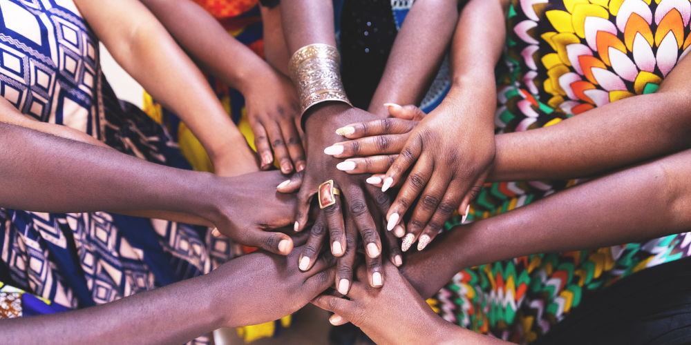 Diverse hands together in unity, symbolizing togetherness and diversity signifying Joreen brands collaboration with the community
