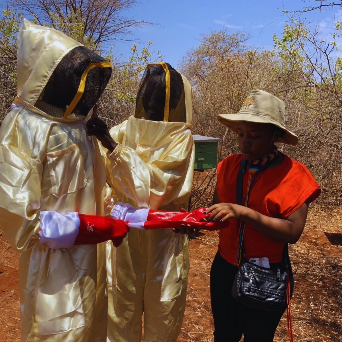 Joreen and team during wearing beekeeping suits during honey harvesting.